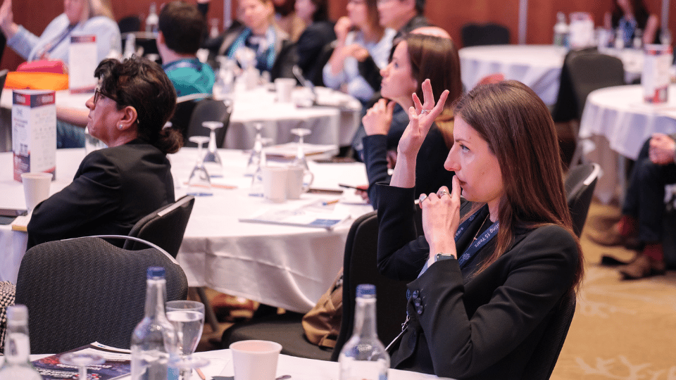 Audience raising their hands